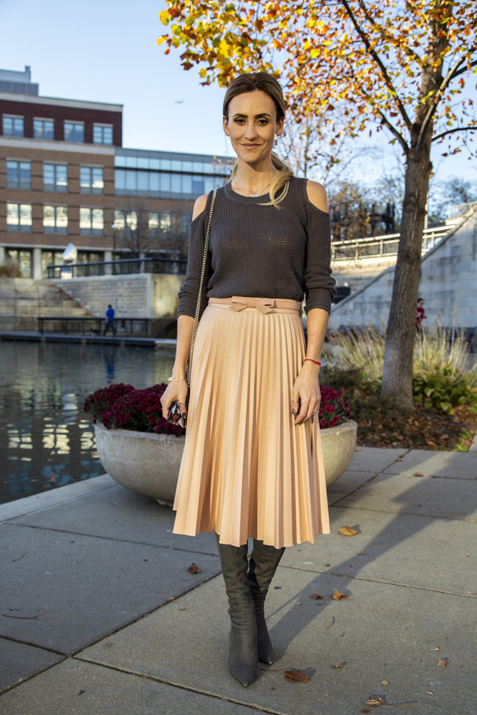 Holiday outfit ideas featured by top Indianapolis fashion blogger, Karina Style Diaries: image of a woman by the river, wearing a Zara pink Pleated Skirt, and a Free People cold shoulder sweater 