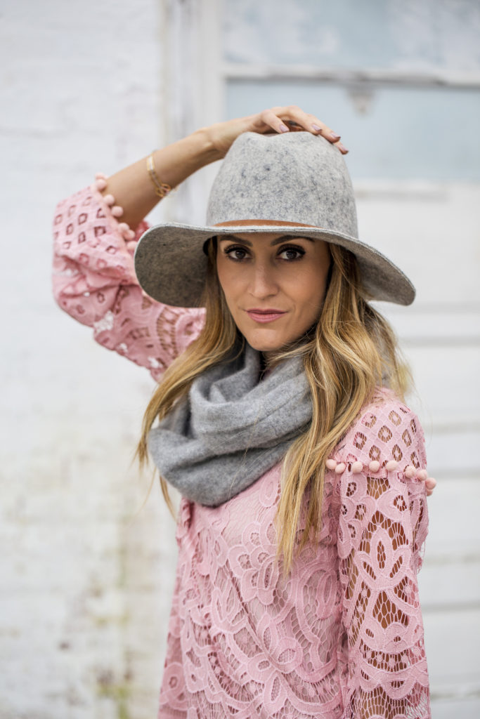 Pink lace crochet dress styled by top US fashion blogger, Karina Style Diaries, for Valentine’s Day: image of a woman wearing a Make Me Chic pink lace crochet dress, Pistil grey scarf, Target grey floppy hat, Stuart Weitzman grey over the knee boots, and a Tory Burch pink handbag