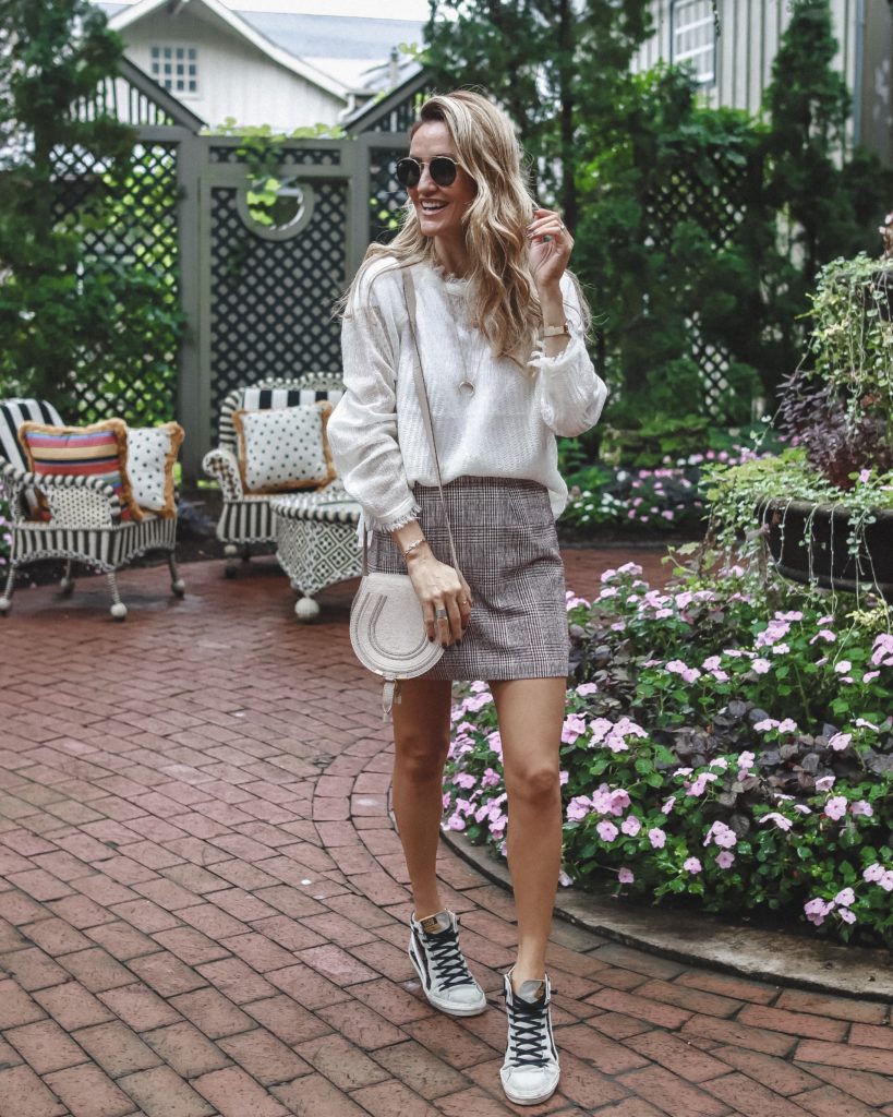 Moon River see through sweater, mini plaid skirt, golden goose sneaks | The Ultimate Short Trip Packing List featured by top Indianapolis travel blogger, Karina Style Diaries