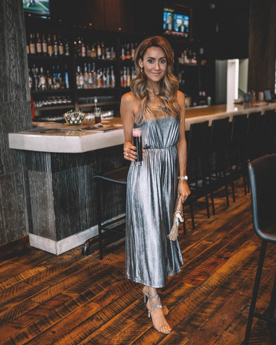BB Dakota metallic jumpsuit | Top Indianapolis fashion blogger, Karina Style Diaries, features the perfect Holiday look with a BB Dakota metallic Jumpsuit: image of a blonde woman wearing a BB Dakota metallic jumpsuit, a BB Dakota faux fur coat, a Sashi clutch and Manolo Blahnik silver heels