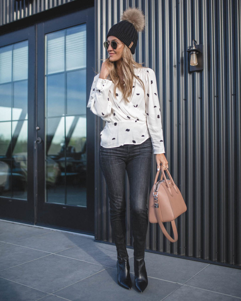Karina Reske | ASTR the label mia top polka dot | black skinny jeans | Black stilleto booties | Givenchy Antigona small bag in Old Pink  | The best polka dot blouse featured by top US fashion blogger, Karina Style Diaries: image of a woman wearing an ASTR polka dot blouse, TOPSHOP black skinny jeans, Charles David leather booties, Givenchy bag, Ray Ban sunglasses and a winter beanie hat.