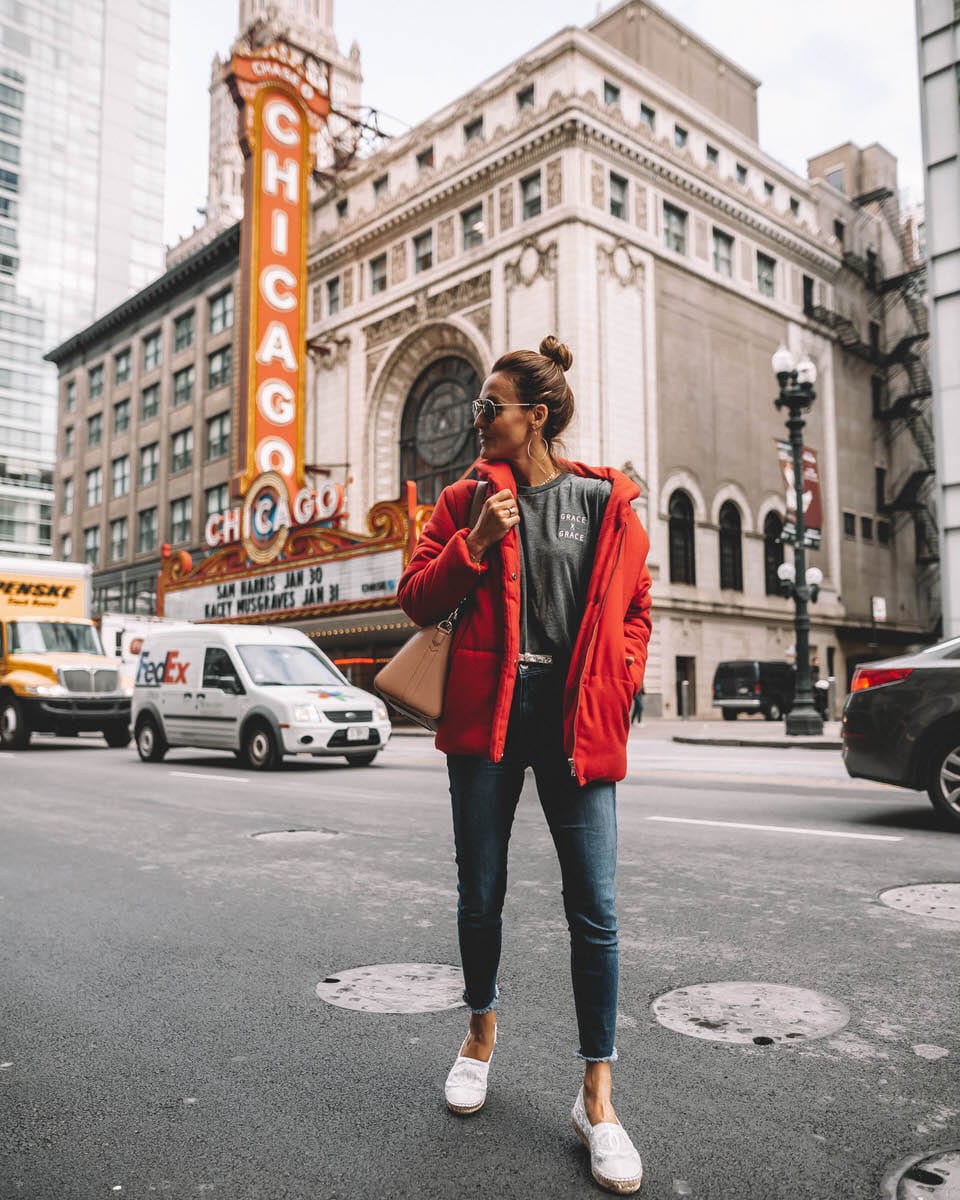 Chicago Theater | Karina Style Diaries | Red puffer Jacket | skinny jeans | chanel espadrilles | Givenchy Antigona | Something Navy red puffer jacket styled by top US fashion blogger, Karina Style Diaries: image of a woman wearing a red puffer jacket, Grace & Grace t-shirt, Good American skinny jeans, Chanel espadrilles, Givenchy small antigona, Ray-Ban aviator sunglasses