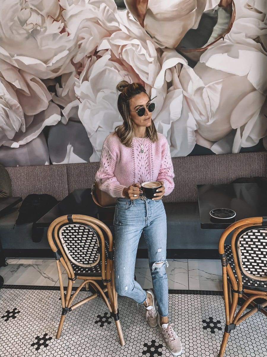 Blogger Karina Reske | Coffee Shop | Pink mohair sweater | pink adidas | levis wedgie | Light pink sweater styled by top Us fashion blogger, Karina Style Diaries: image of a woman wearing an & Other Stories light pink sweater, Gucci Double G leather belt, Levi’s skinny jeans and Adidas pink Gazelle