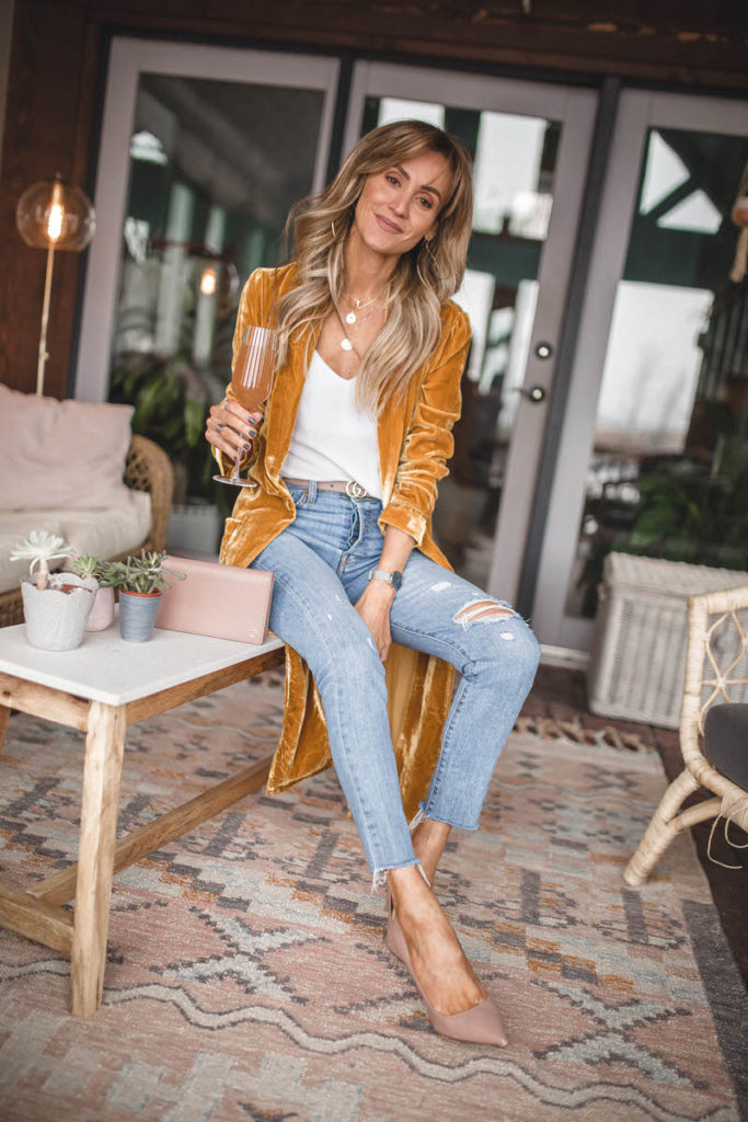 Astr the label long gold velvet duster | Karina Style Diaries | Styling a long velvet duster featured by top US fashion blogger, Karina Style Diaries: image of a woman wearing a gold ASTR long velvet duster, Levi’s ripped skinny jeans, Double G Gucci belt, Gucci Petit Marmont and Sam Edelman Toe Pumps