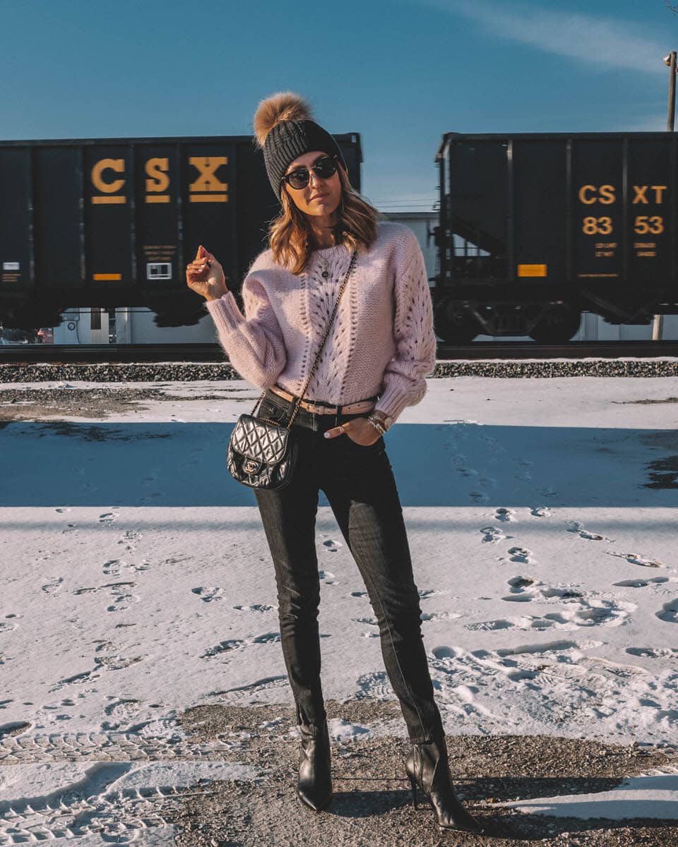 Blogger Karina Reske | Light pink sweater | fur pom pom beanie style | black stiletto booties for winter