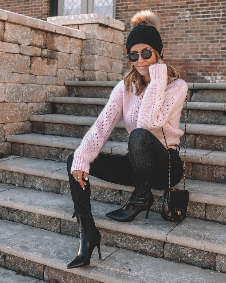 Blogger Karina Reske | Light pink sweater | fur pom pom beanie style | black stiletto booties for winter |Light pink sweater styled by top Us fashion blogger, Karina Style Diaries: image of a woman wearing an & Other Stories light pink sweater, TOPSHOP black jeans, Bevy booties, faux fur pom beanie hat, Chanel cross body bag and Cleo sunglasses
