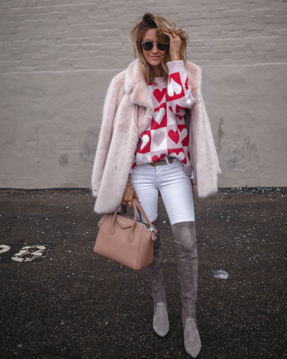 Fiona sweater | Karina reske | heart pattern sweater | over the knee boots | pink fur coat Goodnight Macaroon Valentines Day sweater featured by top US fashion blogger, Karina Style Diaries: image of a woman wearing a Valentines Day sweater, Madewell white skinny jeans, Goodnight Macaroon over the knee suede boots, Free People faux fur coat, Givenchy Antigona, and Ray-Ban aviator sunglasses