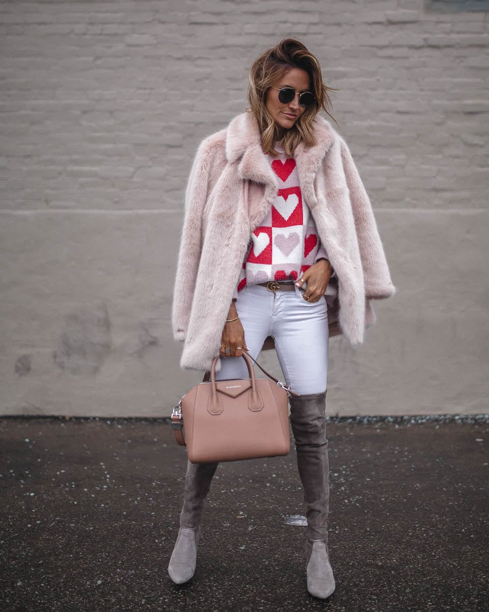 Fiona sweater | Karina reske | heart pattern sweater | over the knee boots | pink fur coat Goodnight Macaroon Valentines Day sweater featured by top US fashion blogger, Karina Style Diaries: image of a woman wearing a Valentines Day sweater, Madewell white skinny jeans, Goodnight Macaroon over the knee suede boots, Free People faux fur coat, Givenchy Antigona, and Ray-Ban aviator sunglasses