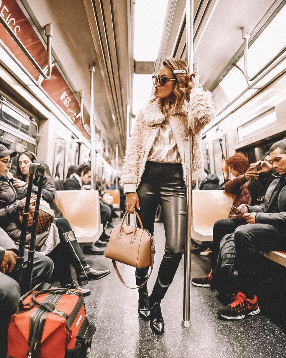 Fashion Blogger Karina Reske | NYC Subway | Gucci barrette | Leather leggings | studded flat booties | givenchy antigona old pink small | NYFW outfits and tips featured by top US fashion blogger, Karina Style Diaries: image of a woman wearing a BlankNyc faux fur bomber jacket, SPRWMN leggings, Mango satin shirt, Rebecca Minkoff Chelsea boots, Gucci bag, sunglasses and barrette