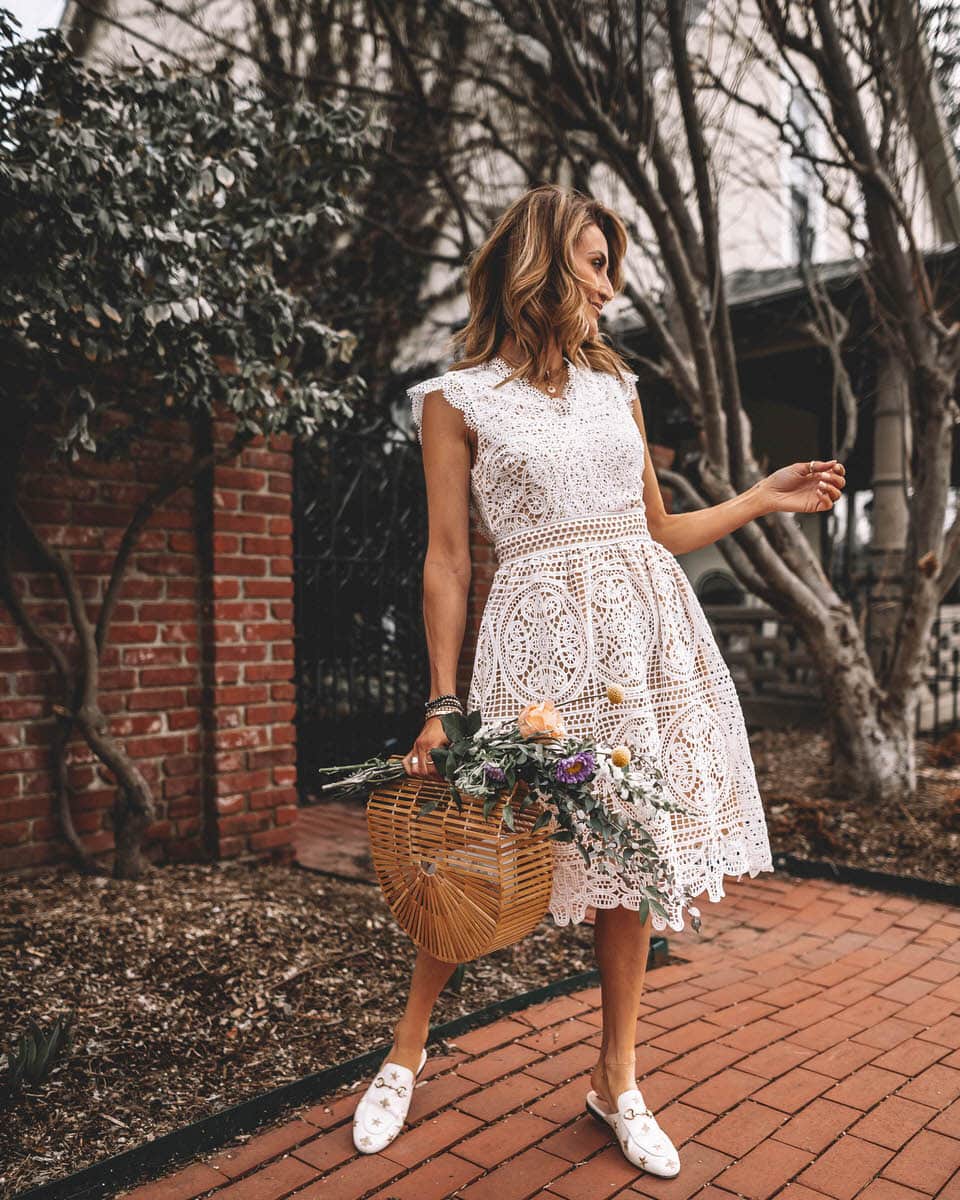 Karina Reske wears a white lace chicwish dress | bamboo bag, flower bouquet | spring white dress | white lace dress | Gucci princetown embroidered loafers