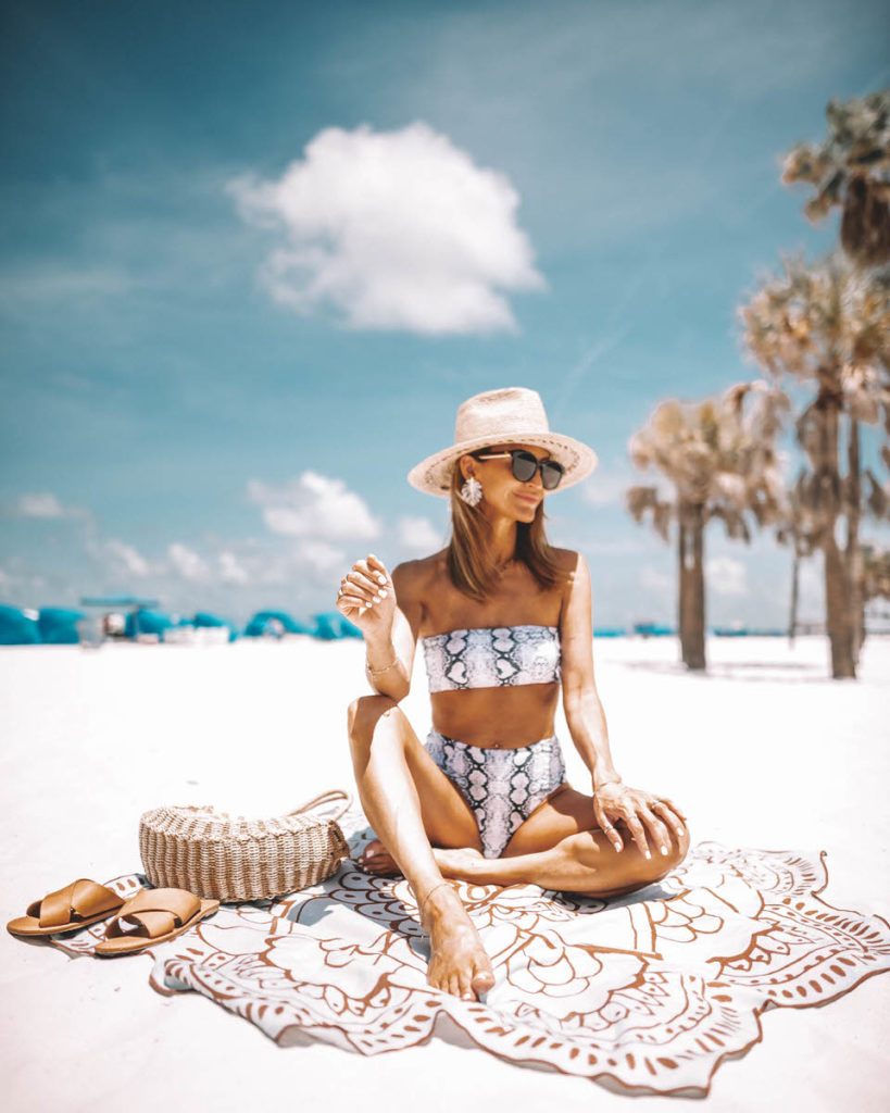 Fashion Blogger Karina Style Diaries | snake skin bathing suit | bandeau bathing suit | high rise bathing suit | beach photo | lotus towel | woman in bathing suit seasting on the sand