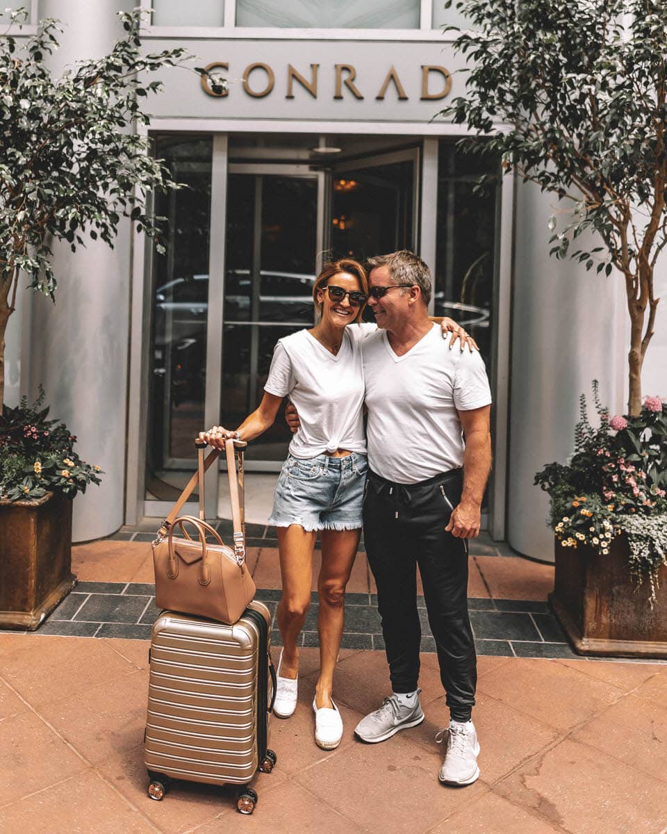 Karina Style Diaries and husband at the Conrad Hotel wearing jockey joggers cut off jeans shorts plain withe tee