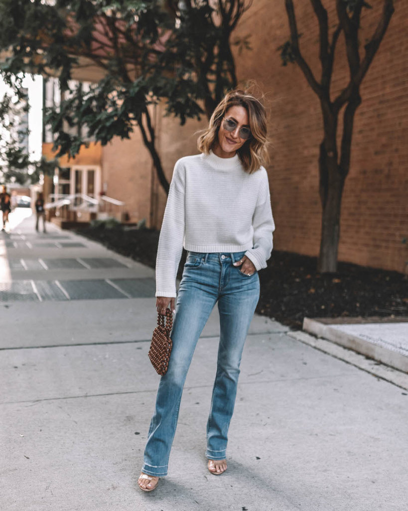 Karina Style Diaries wears barely boot cut jeans clear vinyl heels mock pullover white knit sweater wooden beaded purse fall styles