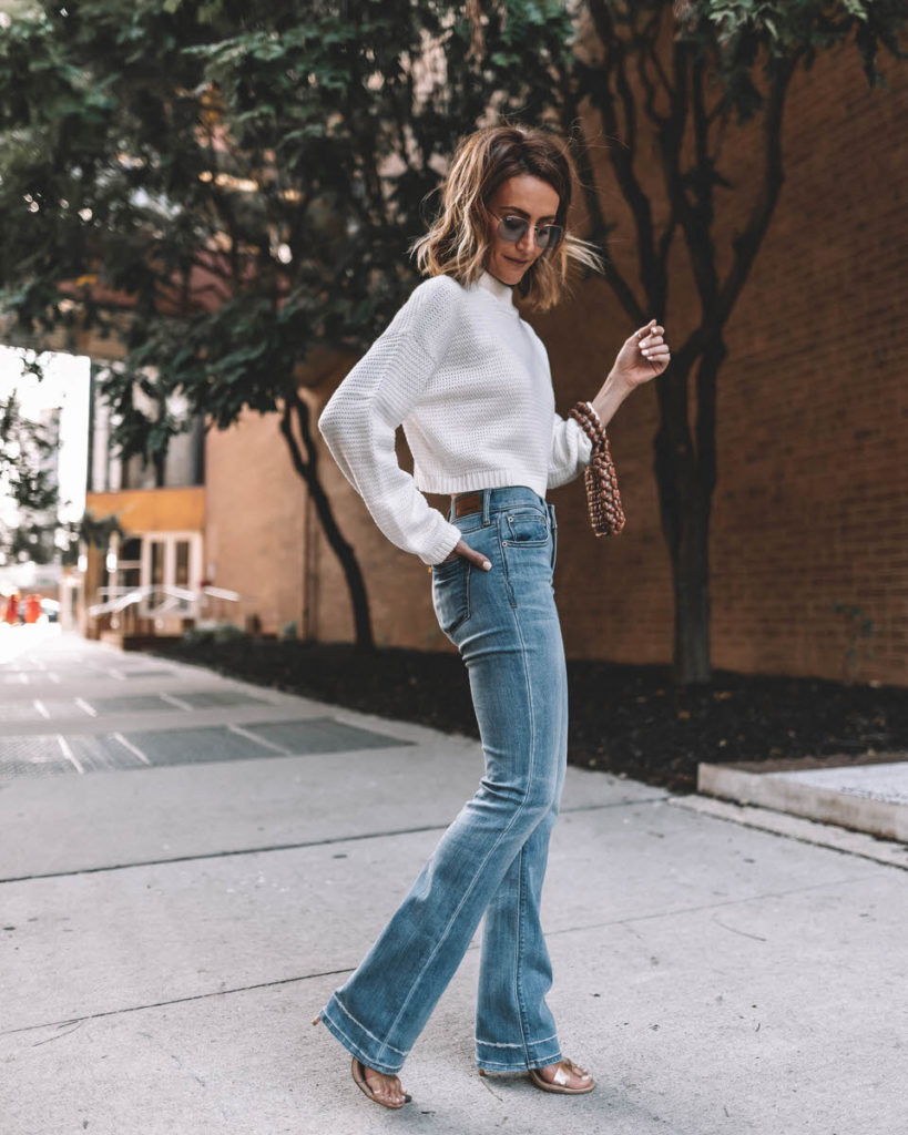 Karina Style Diaries wears barely boot cut jeans clear vinyl heels mock pullover white knit sweater wooden beaded purse fall styles