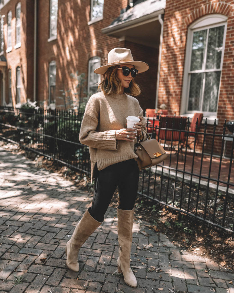 Karina Style Diaries wearing spanx faux leather leggings tan oversized sweater tall suede tan boots lack of color hat