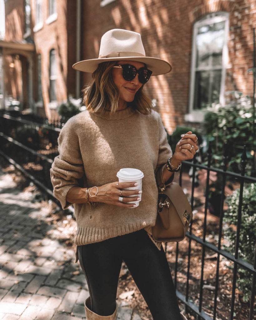 Karina Style Diaries wearing spanx faux leather leggings tan oversized sweater tall suede tan boots lack of color hat