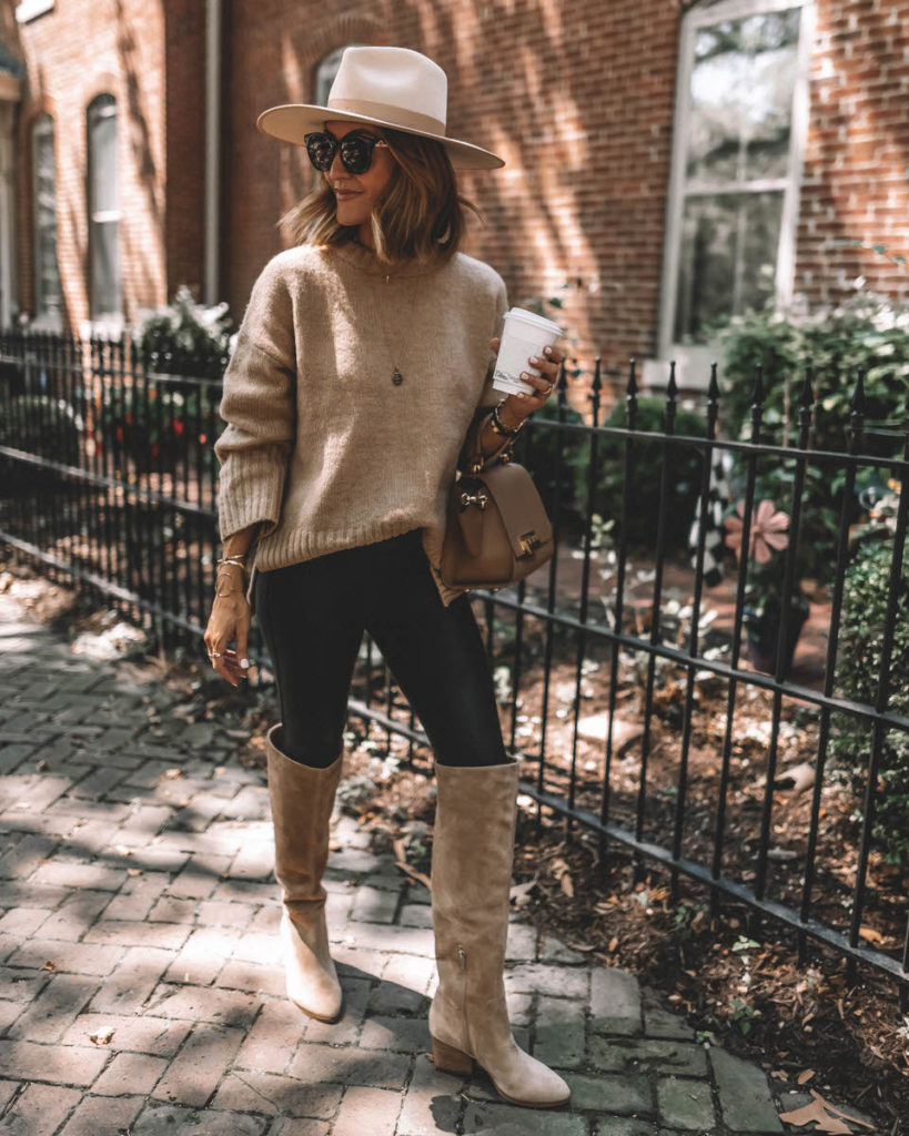 Karina Style Diaries wearing spanx faux leather leggings tan oversized sweater tall suede tan boots lack of color hat
