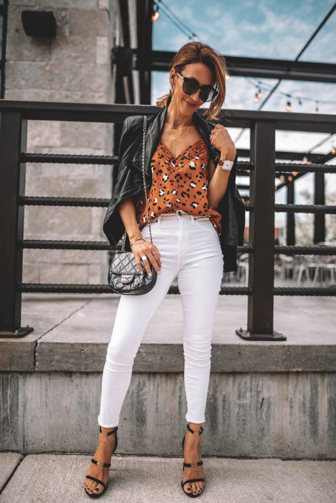 Karina Style Diaries wearing white jeans chic outfit leo print cami black leather jacket chanel bubble crossbody bag tamara mellon reverse sandals
