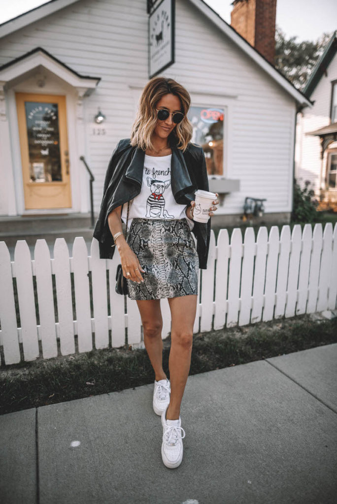 Karina Style Diaries wearing Le Frenchie tee snakeskin mini skirt leather jacket over the shoulder white sneakers coffee shop look