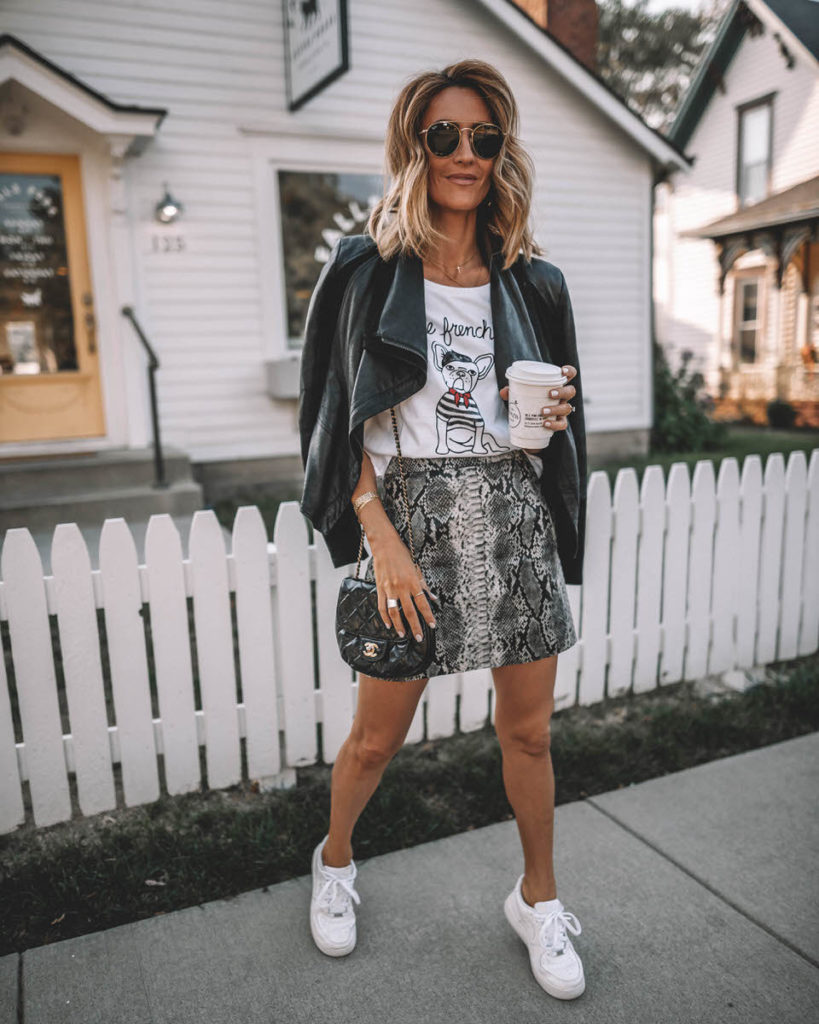 Karina Style Diaries wearing Le Frenchie tee snakeskin mini skirt leather jacket over the shoulder white sneakers coffee shop look