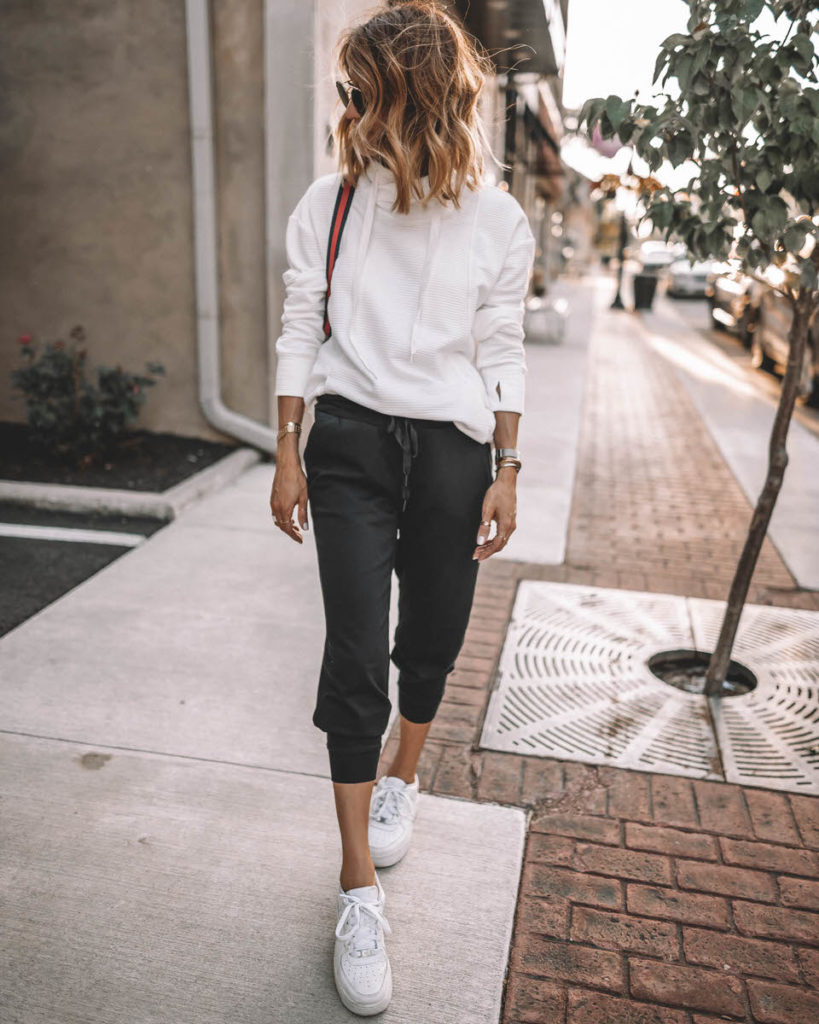 Karina Style Diaries wearing white cowl neck sport pullover black joggers white snekakers casual black & white outfit