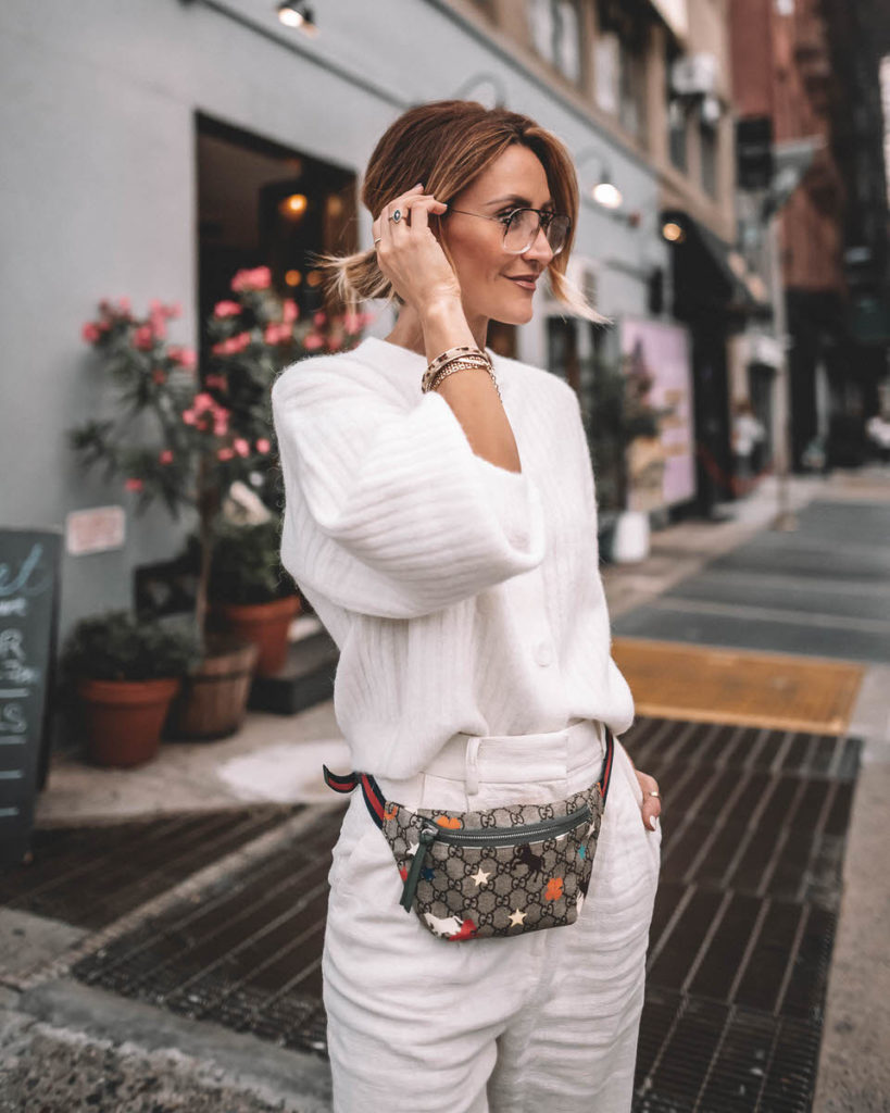 Karina Style Diaries wearing cream monochromatic outfit high waist linen pants oversized sweater and tee gucci belt bag gucci princetown bumble bee loafers