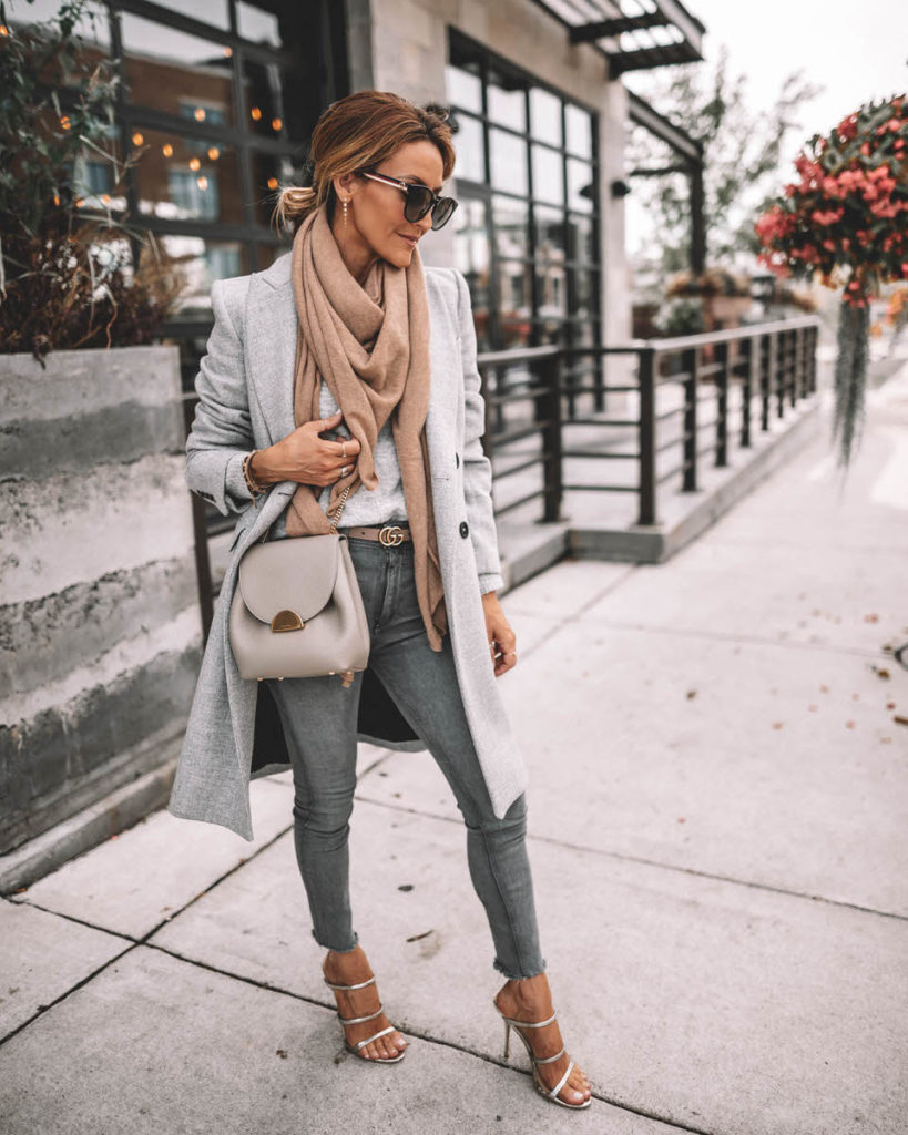 Karina Style Diaries wearing structured grey coat camel cashmere scarf grey skinny jeans gucci belt Polene Numero Un mini grey silver strappy sandals