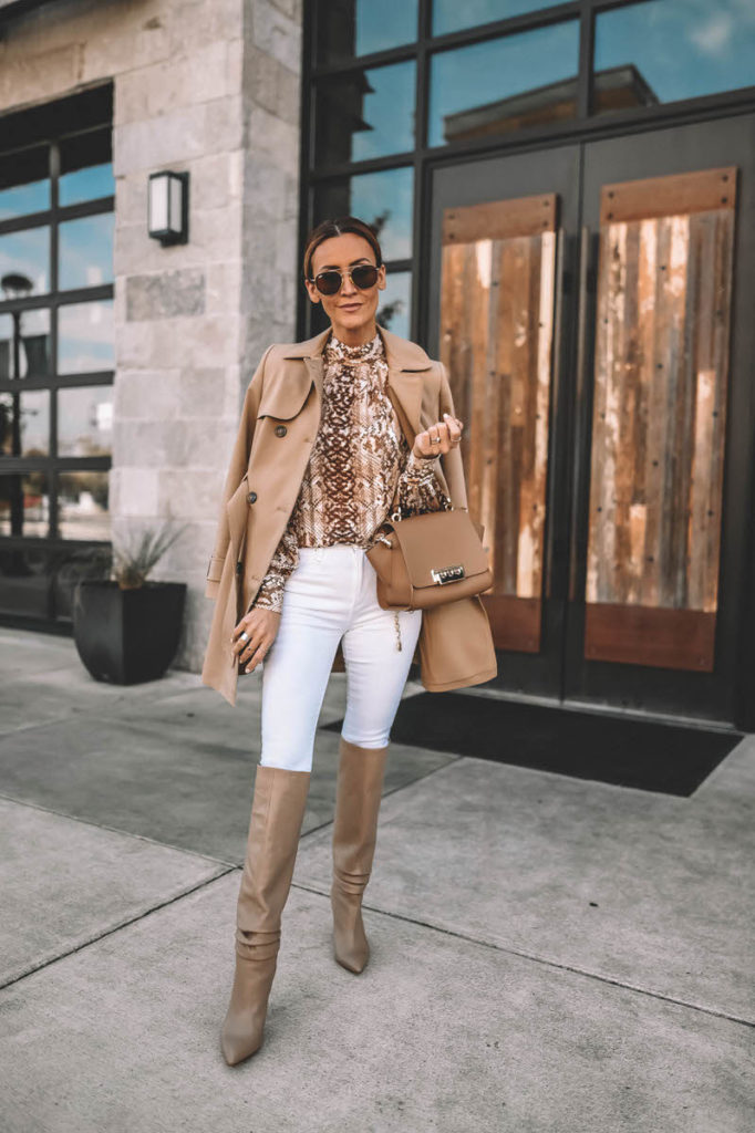 Fashion Blogger Karina Reske wearing white skinny jeans snakeskin print blouse gold chain belt knee high slouchy boots Zac Posen Eartha handbag camel trench coat outfit