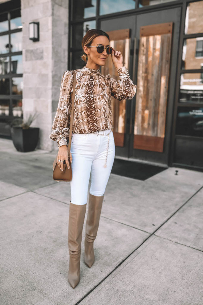 Fashion Blogger Karina Reske wearing white skinny jeans snakeskin print blouse gold chain belt knee high slouchy boots Zac Posen Eartha handbag