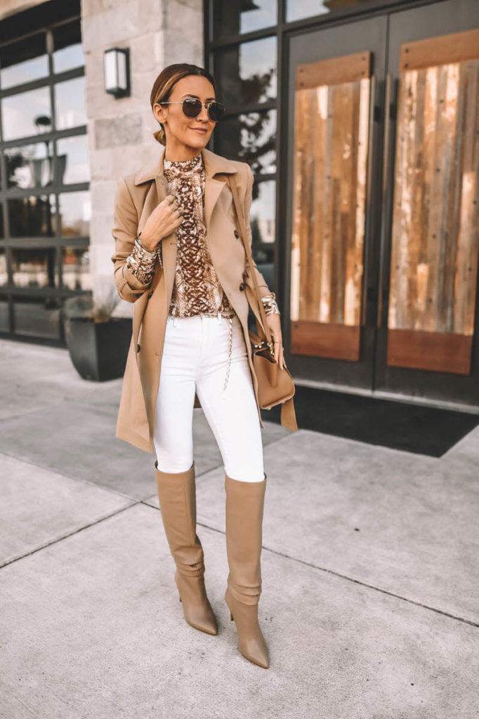 Fashion Blogger Karina Reske wearing white skinny jeans snakeskin print blouse gold chain belt knee high slouchy boots Zac Posen Eartha handbag camel trench coat outfit