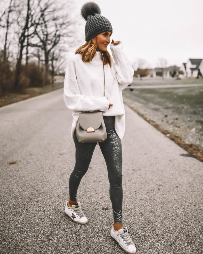 Karina Style Diaries wearing foil silver leggings oversized white sweater blanket scarf pompom beanie winter style