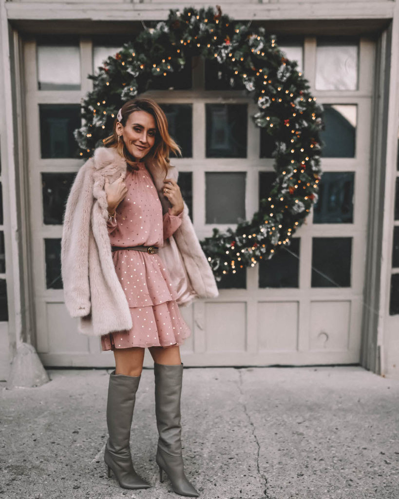 Karina Style Diaries wearing polka dot ruffle blush mini dress faux fur nude coat tall slouchy grey boots Holiday Outfit