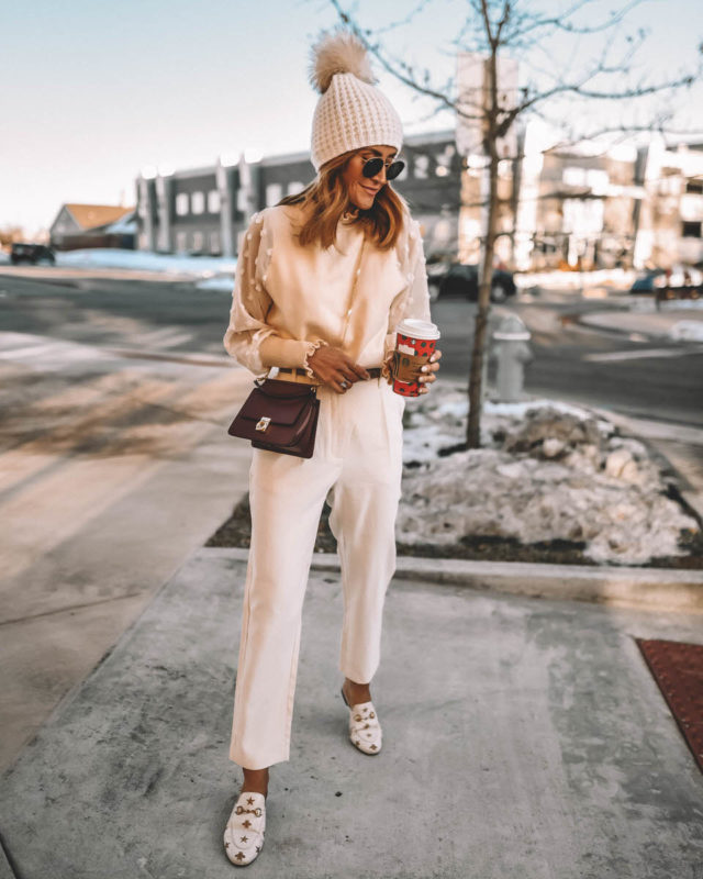 monochromatic cream outfit high waisted pants sheer sleeve sweater pompom beanie Gucci loafers Polene Paris Numero Sept mini