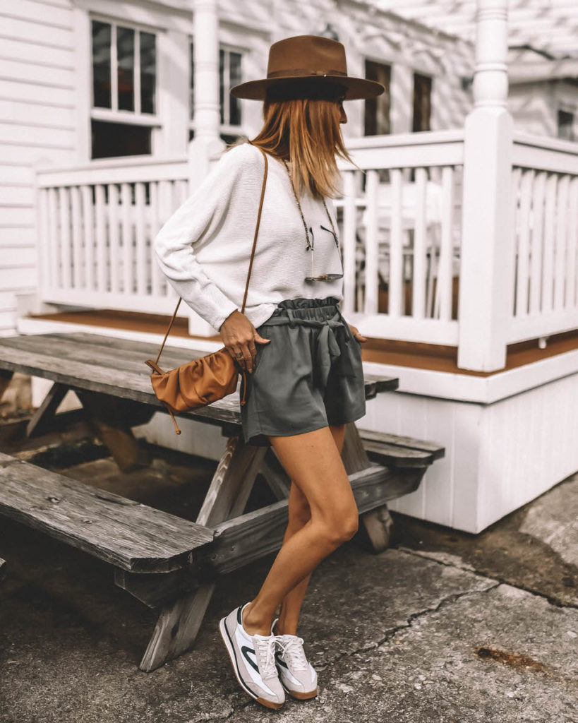 Karina Style Diaries wearing sage paperbag shorts tretorn sneakers western hat dolman sleeve white sweater spring outfit