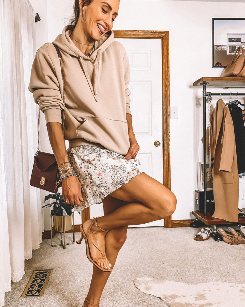 Karina Style Diaries wearing a hoodie with a mini dress nude strappy heels