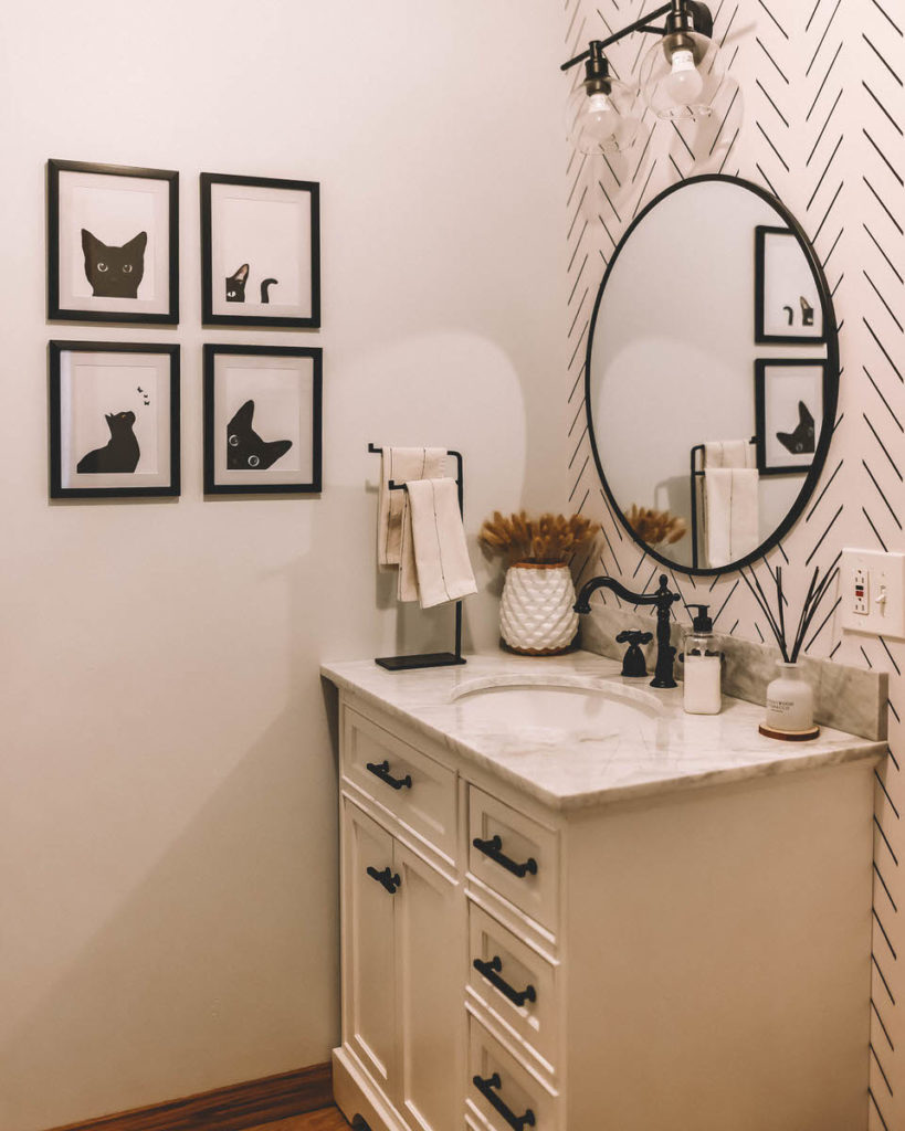 Black and White Bathroom Makeover marble vanity round black metal edge mirror wallpaper