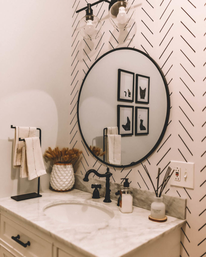 Black and White Bathroom Makeover marble vanity round black metal edge mirror wallpaper