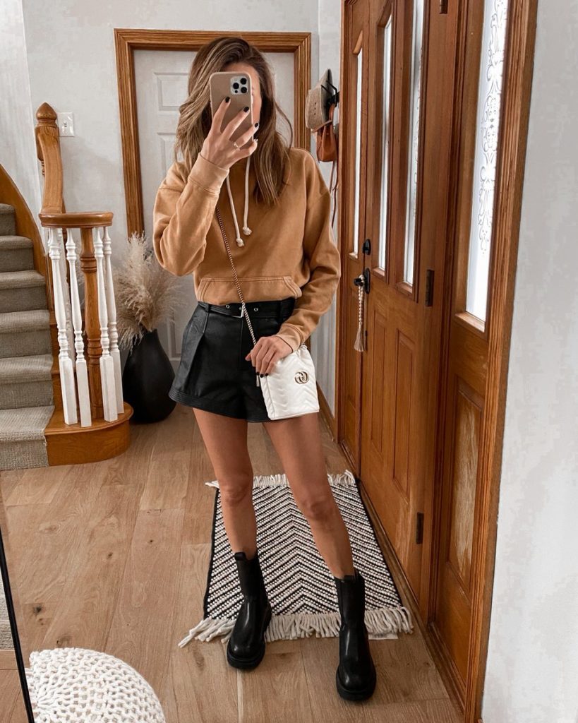 Hooded sweatshirt, faux leather shorts, gucci bucket bag, lug boot outfit