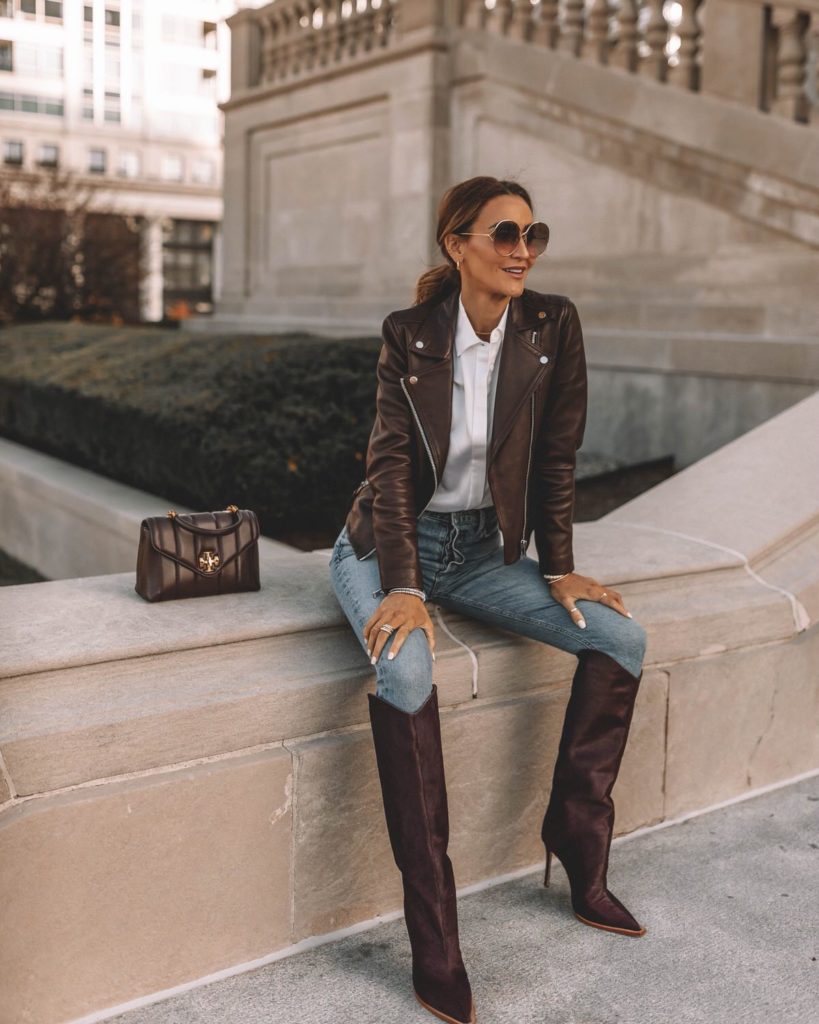Karina wears schutz knee high boot with skinny jean and leather jacket