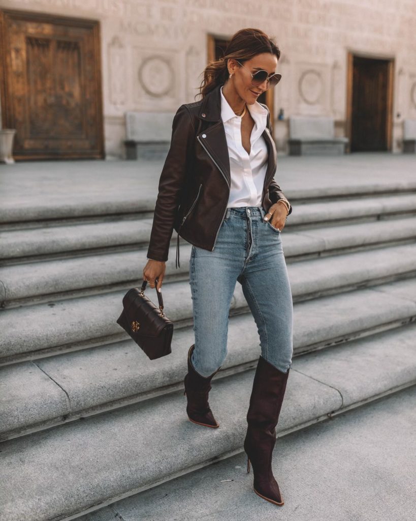 Karina wears schutz knee high boot with skinny jean and leather jacket
