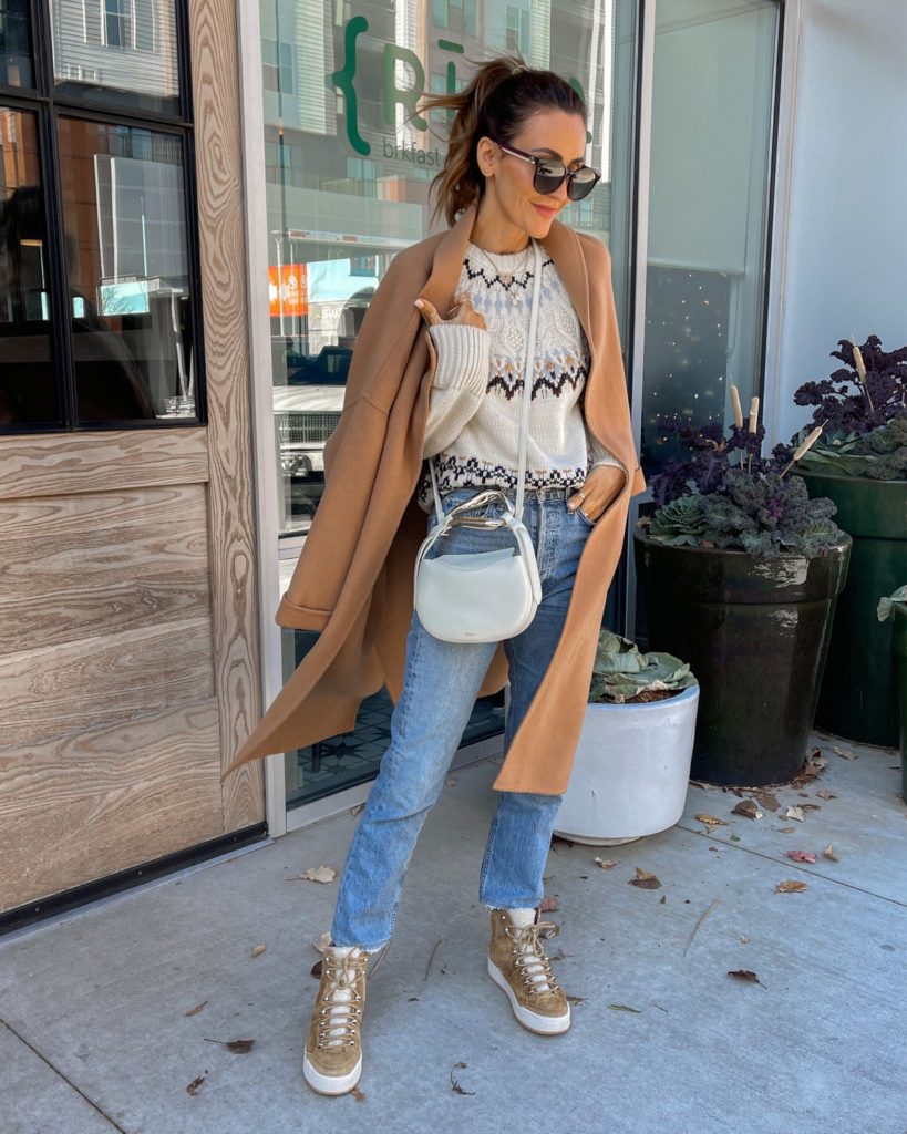 Karina wears chloe bag with sweater and straight leg jeans and camel coat