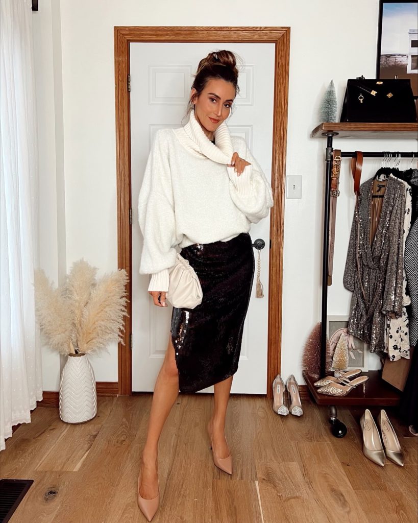 karina wears express sequin skirt with white oversized sweater