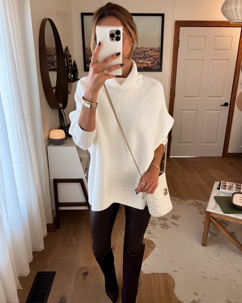 karina wears white amazon sweater with faux leather leggings and schutz boots