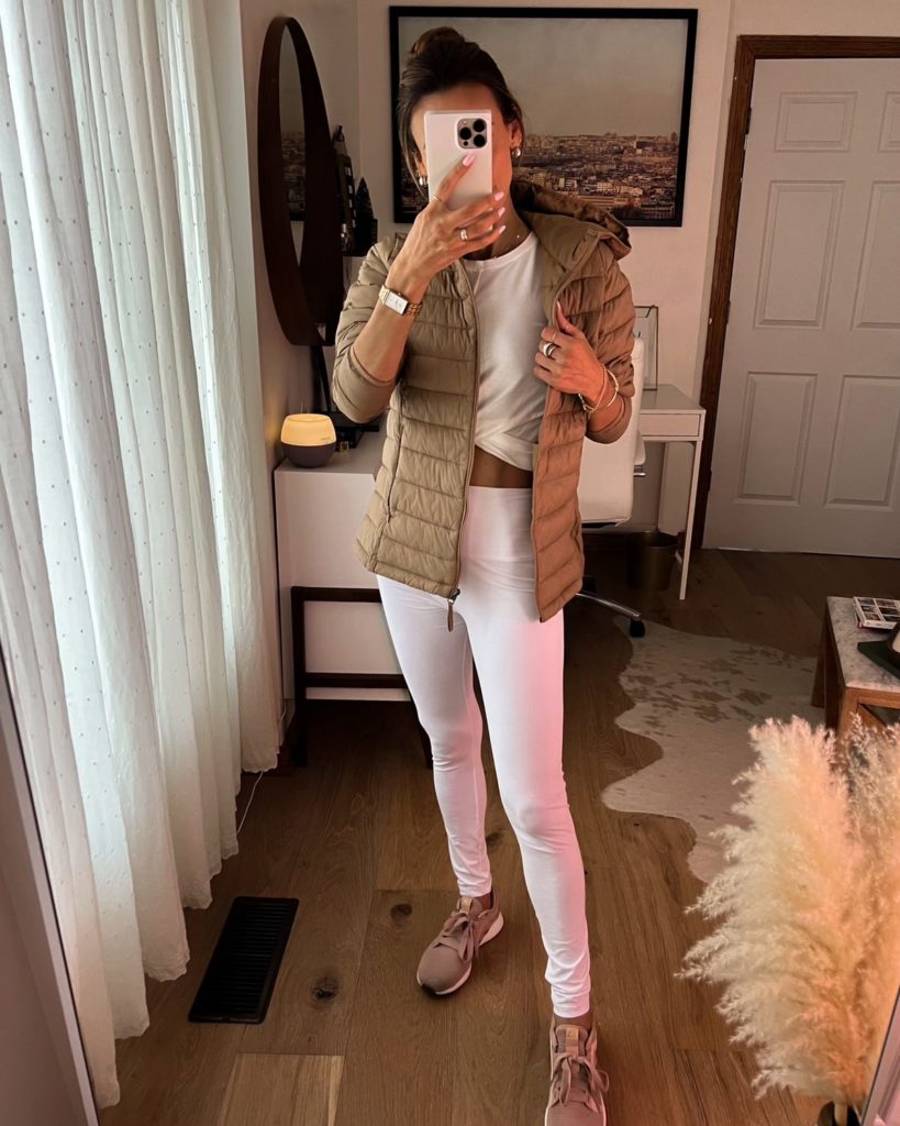 karina wears white amazon workout set with tan puffer jacket