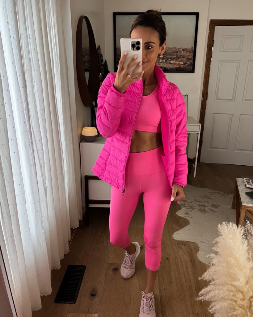 karina wears pink amazon workout set with pink puffer jacket