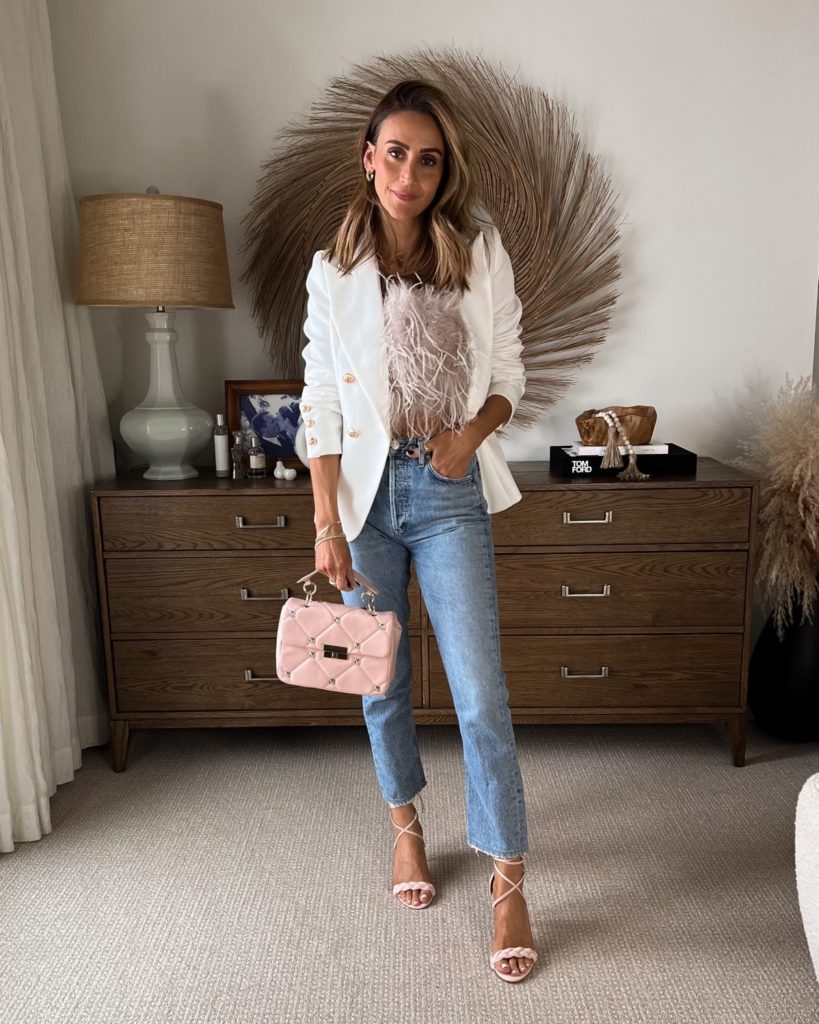 Karina wears lamarque feather top with white blazer and straight jeans