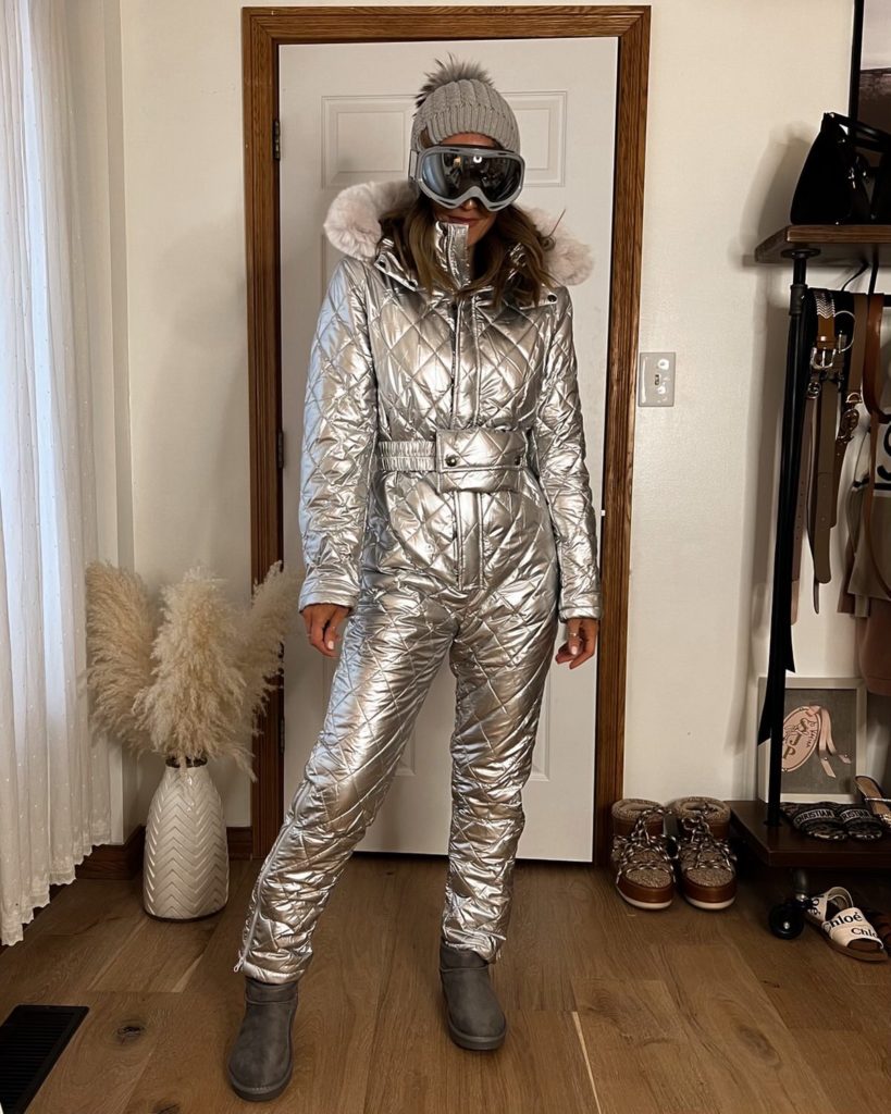 Karina wears amazon silver ski suit onesie with beanie and ski goggles