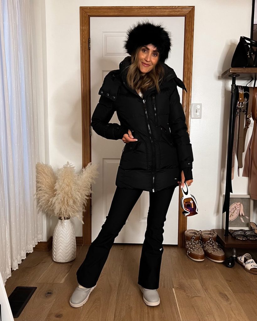 karina wears all black skit outfit northface ski pants and faux fur headband