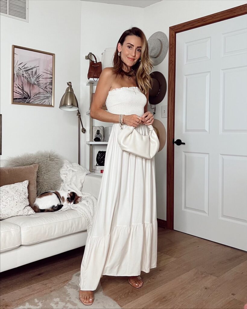 Karina wears white amazon maxi strapless dress with amazon handbag