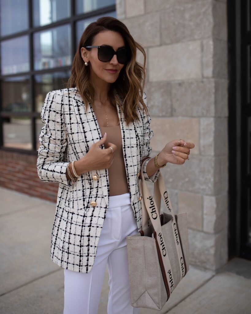 karina wears express white trousers with tan tank top and tweed blazer with chloe bag
